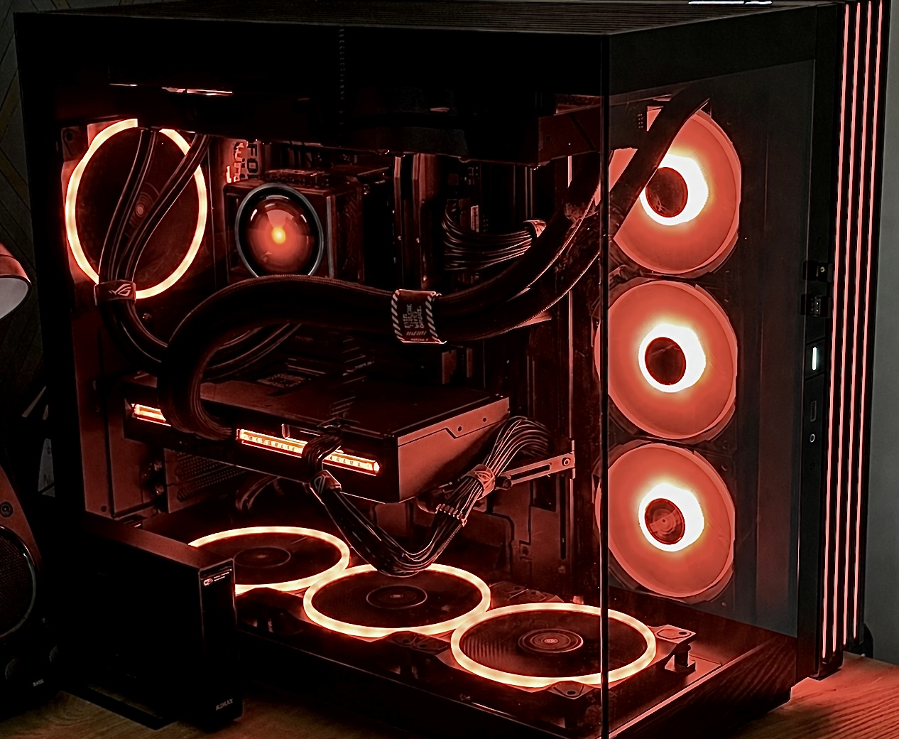 Owner-supplied UDS development workstation with liquid cooling, multiple illuminated fans and a large graphics card visible through the glass side panel